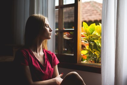 woman meditating by a window