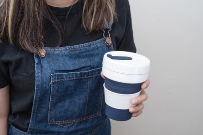 Woman carrying a reusable mug