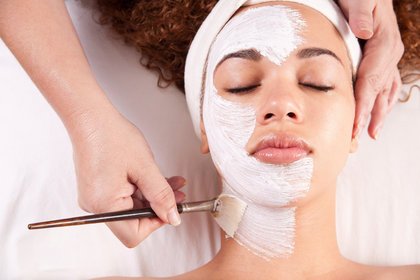 Woman receiving facial spa treatment