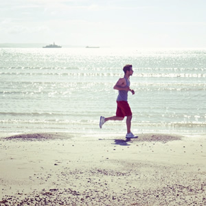 man jogging on the beach - Image Credit: Kate hiscock (Flickr)