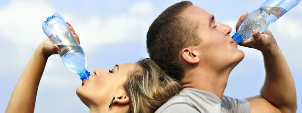 couple drinking water from bottles
