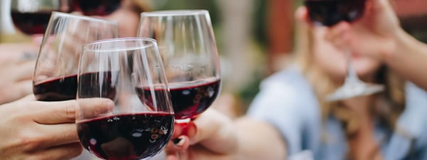 Group toasting with red wine