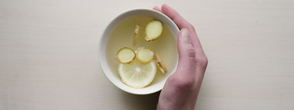 hand around lemon and ginger tea