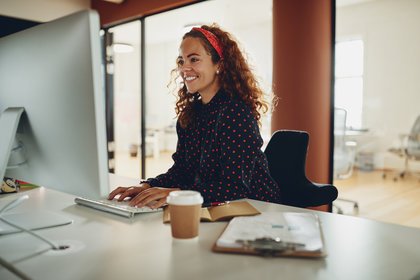 Young happy woman working in office