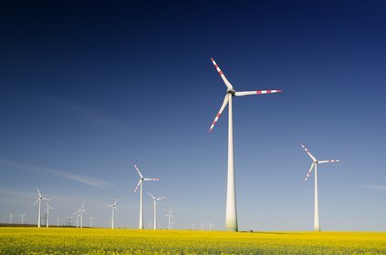 windmills on grass field at daytime