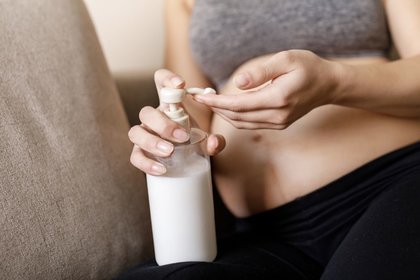 Person putting cream on their bump