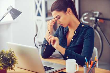 Woman at desk stressed