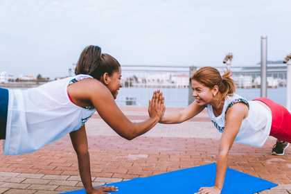 two women doing push up