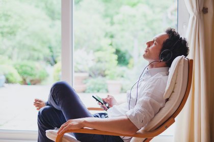 Young man meditating at home