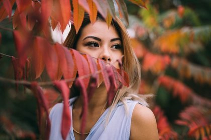 Woman near autumn trees