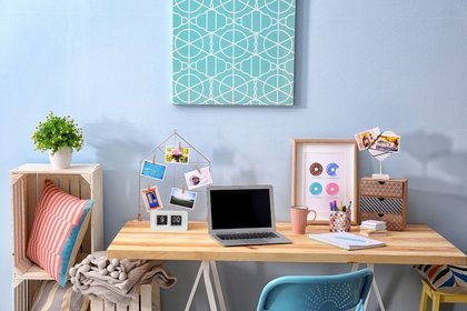 Wooden desk with photos and laptop