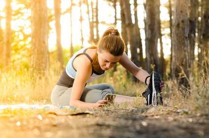 A lady stretching outside before running