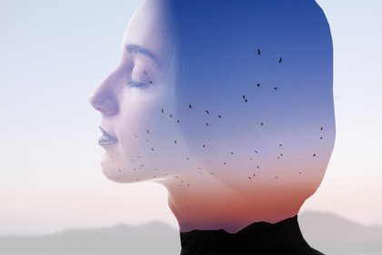 Mindful woman double-exposure with sunset