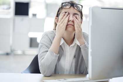 tired woman at desk