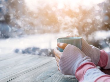 Woman holding mug in winter