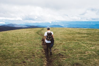 Man walking through hills