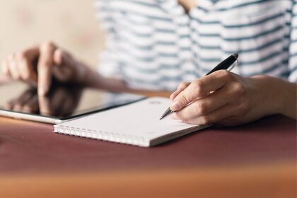 Person writing in journal