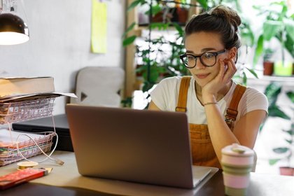 Woman working on laptop at a table