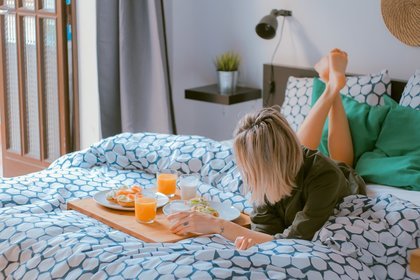 Woman having breakfast in bed